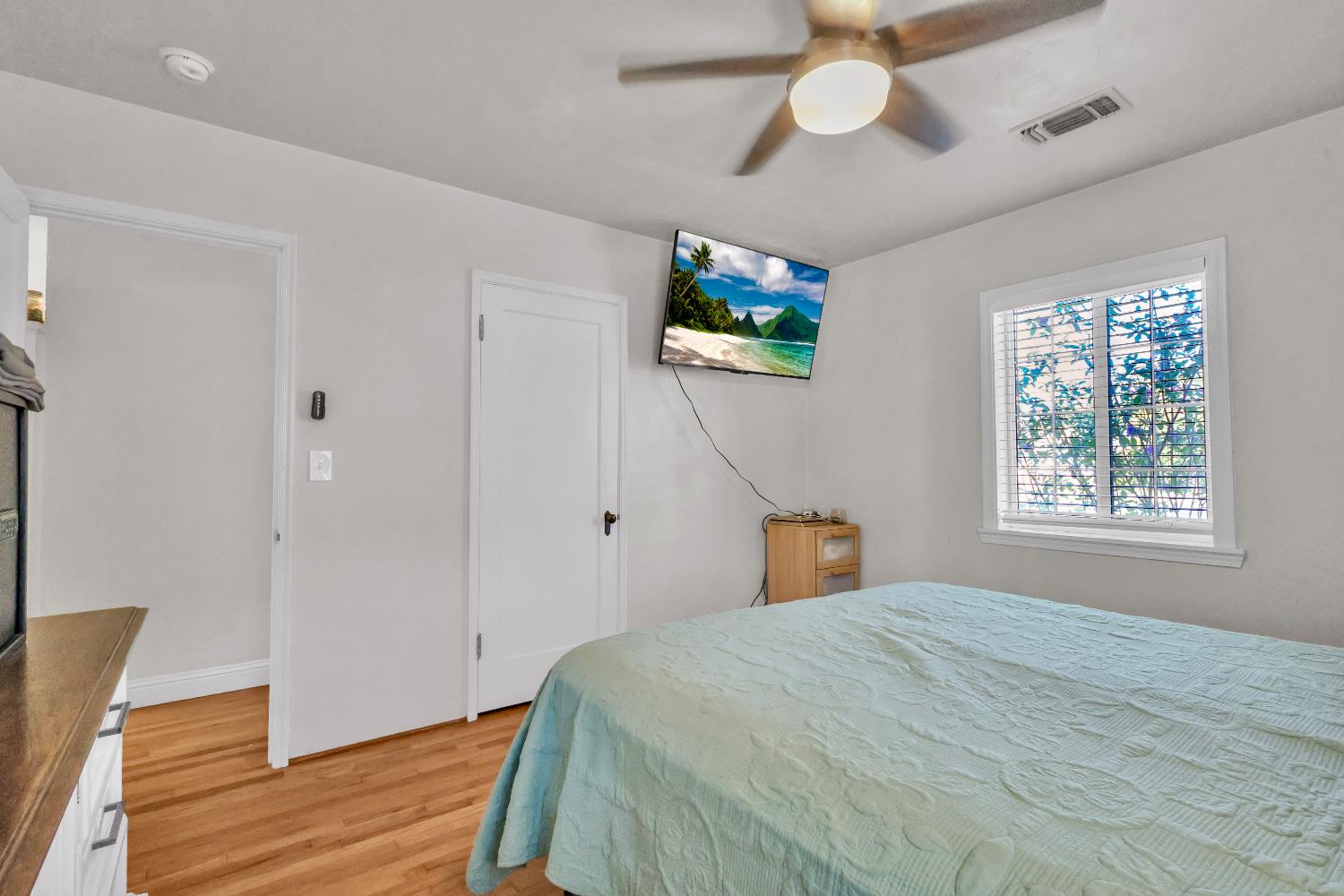 606 West Turner Road Lodi, CA 95240 - Photo 22 of 41 a bedroom with a bed and a chandelier