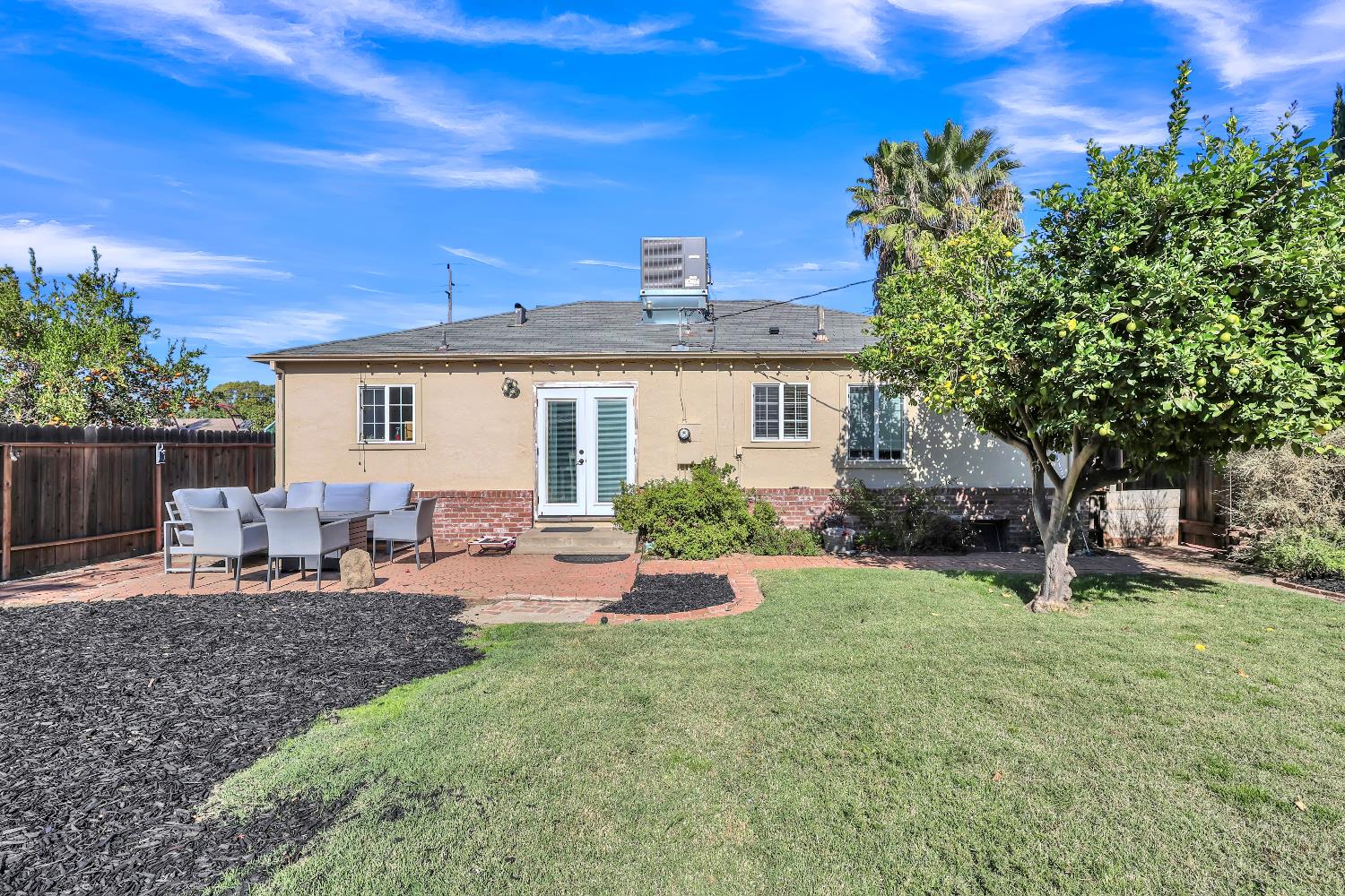 606 West Turner Road Lodi, CA 95240 - Photo 4 of 41 a view of a house with backyard sitting area and garden