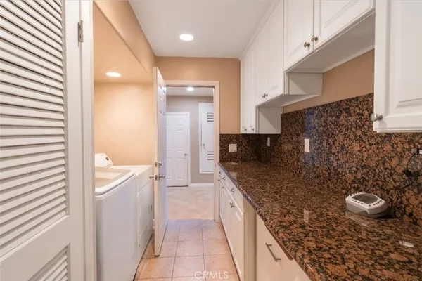 a spacious bathroom with a granite countertop sink a mirror and a shower