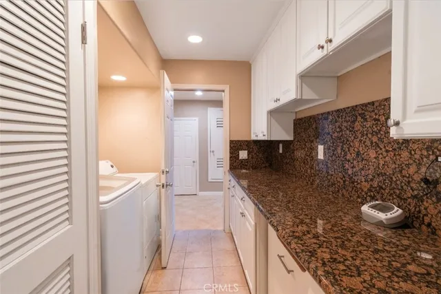 a spacious bathroom with a granite countertop sink a mirror and a shower
