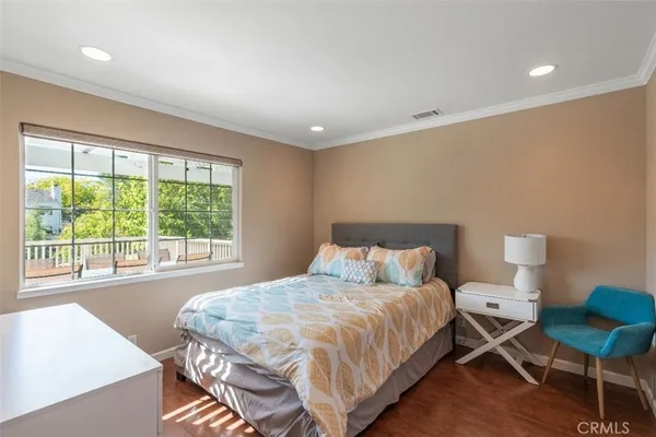 a bedroom with a bed and a chair