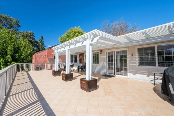 a view of a house with backyard sitting area and porch