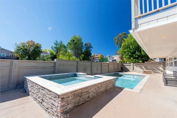 a view of a backyard with a table and chairs