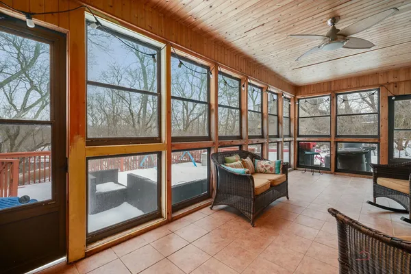 a living room with furniture and a floor to ceiling window
