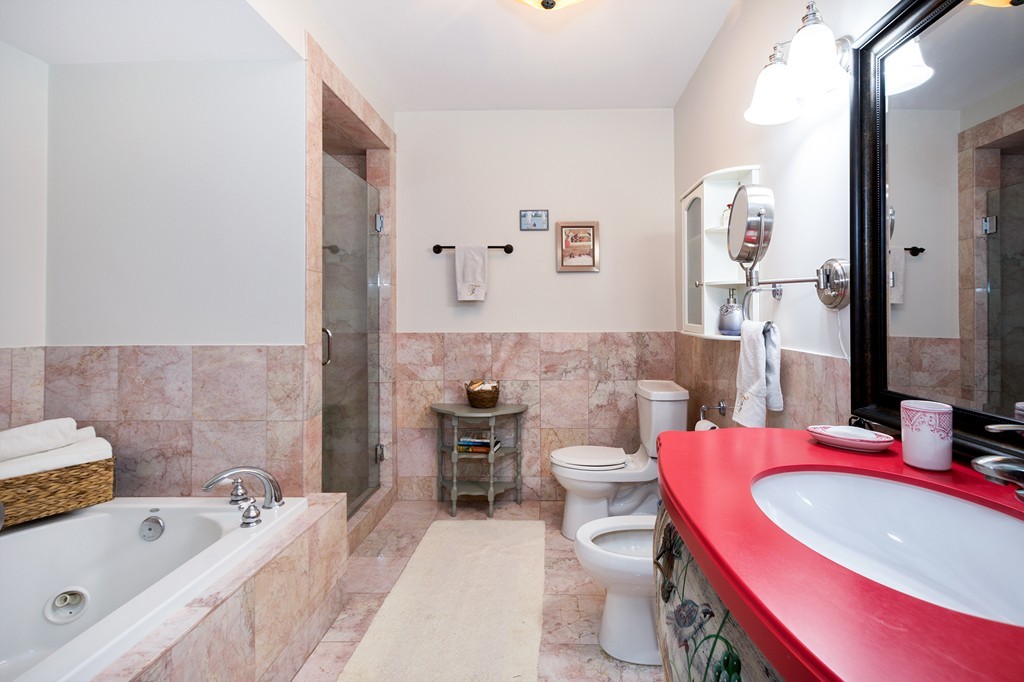 15 Park Avenue, Unit 401 Hull, MA 02045 - Photo 15 of 24 a bathroom with a sink a toilet and tub