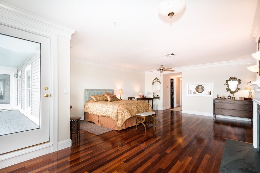15 Park Avenue, Unit 401 Hull, MA 02045 - Photo 17 of 24 a spacious bedroom with a bed and a dresser