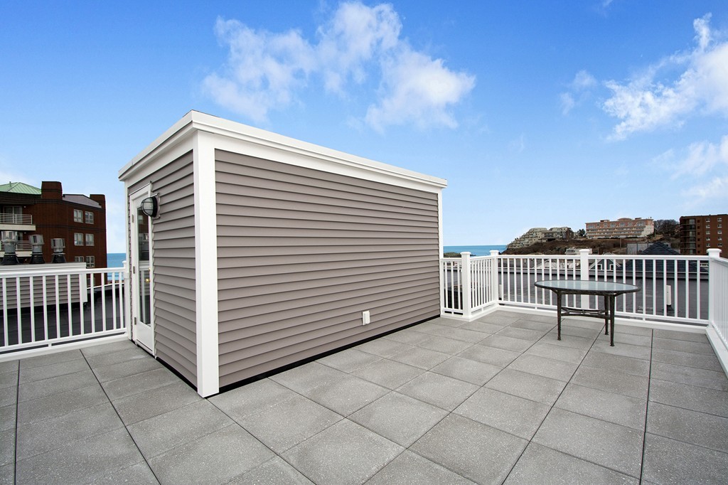 15 Park Avenue, Unit 401 Hull, MA 02045 - Photo 18 of 24 a view of a terrace with a chair and iron fence