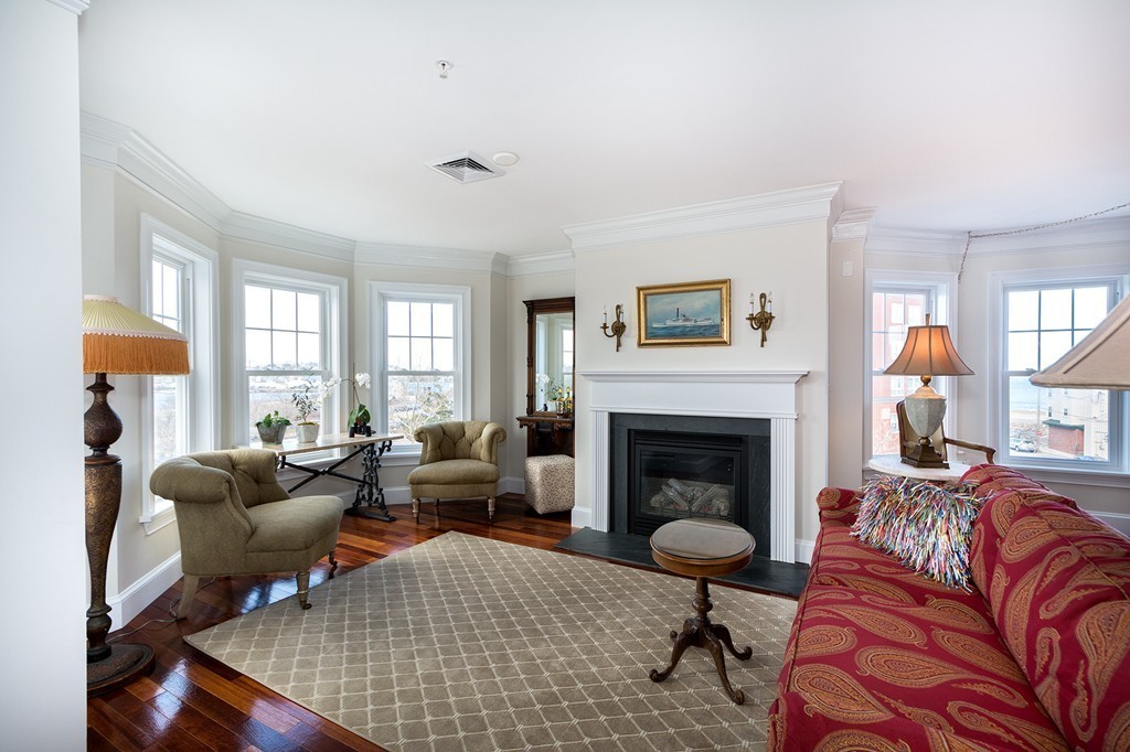 15 Park Avenue, Unit 401 Hull, MA 02045 - Photo 3 of 24 a living room with furniture windows and a fireplace