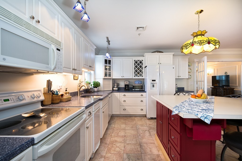 15 Park Avenue, Unit 401 Hull, MA 02045 - Photo 7 of 24 a kitchen with a counter space a sink appliances and cabinets