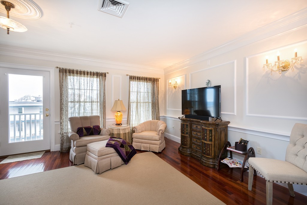 15 Park Avenue, Unit 401 Hull, MA 02045 - Photo 10 of 24 a living room with furniture and a flat screen tv