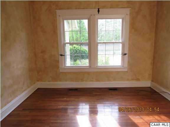 289 Bremo Bluff Road Bremo Bluff, VA 23022 - Photo 3 of 10 an empty room with wooden floor and windows