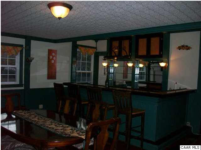 289 Bremo Bluff Road Bremo Bluff, VA 23022 - Photo 4 of 10 a dining room with table chairs and a fireplace