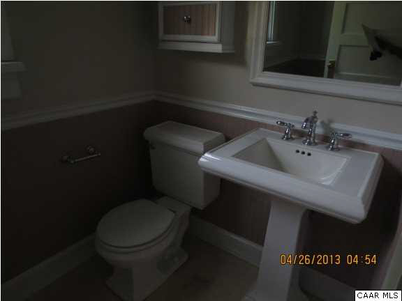289 Bremo Bluff Road Bremo Bluff, VA 23022 - Photo 7 of 10 a bathroom with a toilet sink and mirror
