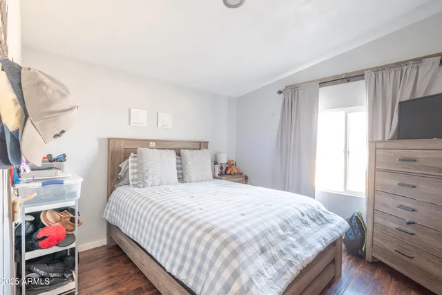 a bedroom with a bed and a window