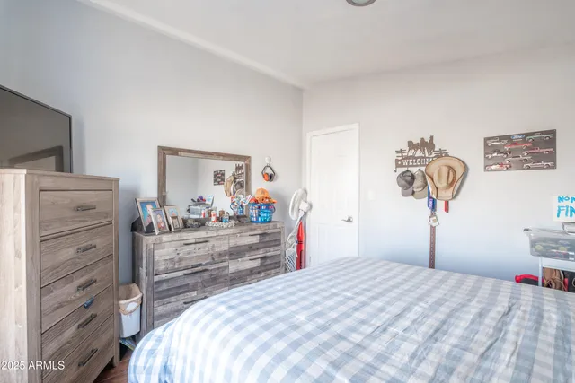 a bedroom with a bed and a dresser