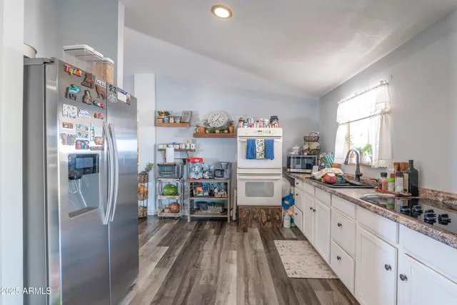 a kitchen with stainless steel appliances a sink and cabinets