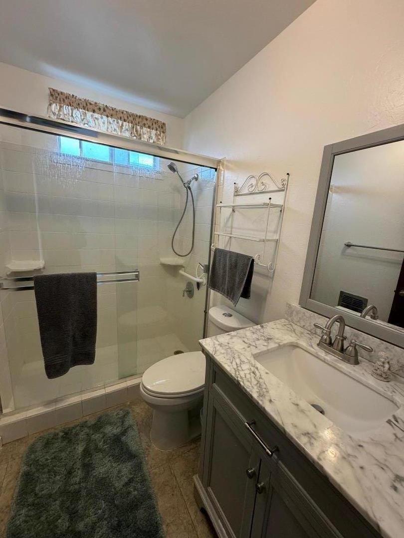 1261 Juniper Drive, Unit 12 Gilroy, CA 95020 - Photo 8 of 9 a bathroom with a granite countertop sink toilet and shower