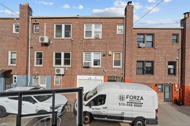 a view of a brick building with many windows
