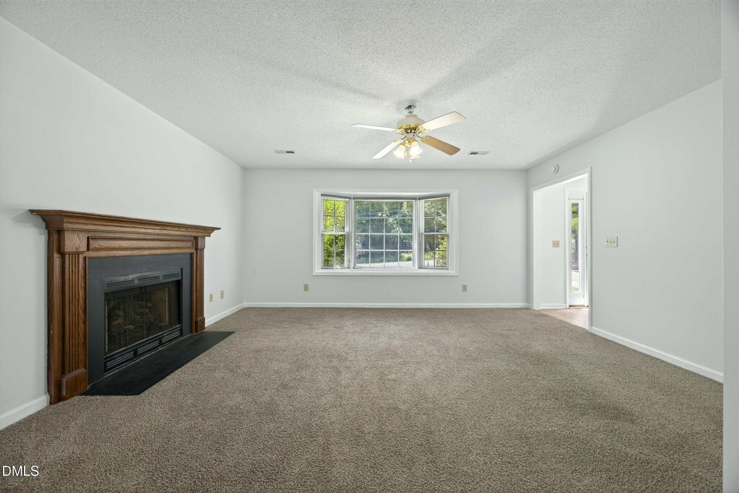 1901 Whites Mill Road High Point, NC 27265 - Photo 6 of 24 an empty room with windows and fireplace