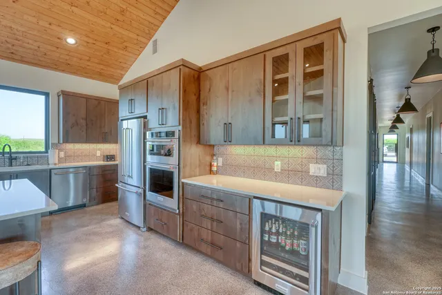 a kitchen with a refrigerator and a sink
