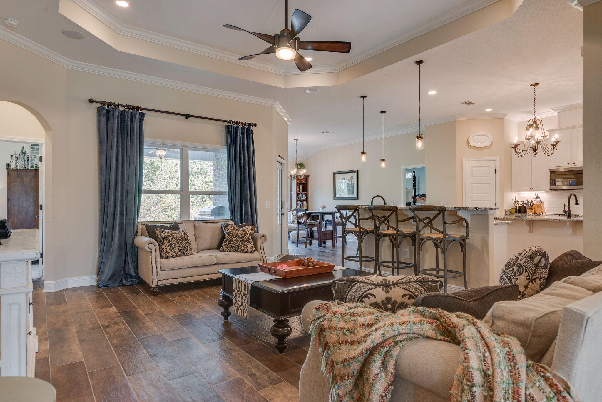 8640 Sand Pine Drive Navarre, FL 32566 - Photo 12 of 58 a living room with furniture fireplace and a chandelier