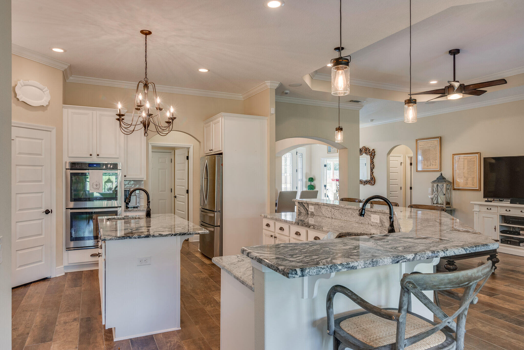 8640 Sand Pine Drive Navarre, FL 32566 - Photo 16 of 58 a kitchen with kitchen island granite countertop a sink and cabinets