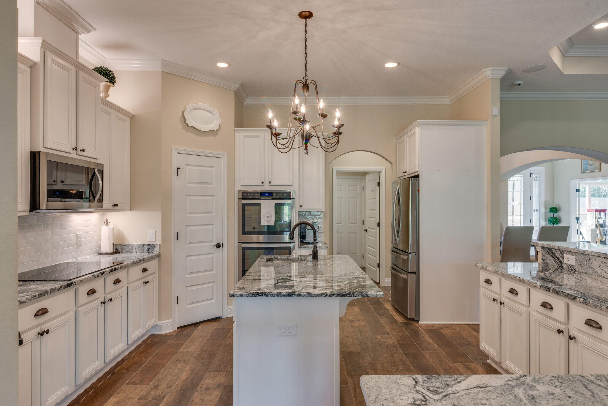 8640 Sand Pine Drive Navarre, FL 32566 - Photo 17 of 58 a kitchen with granite countertop a sink stove and refrigerator