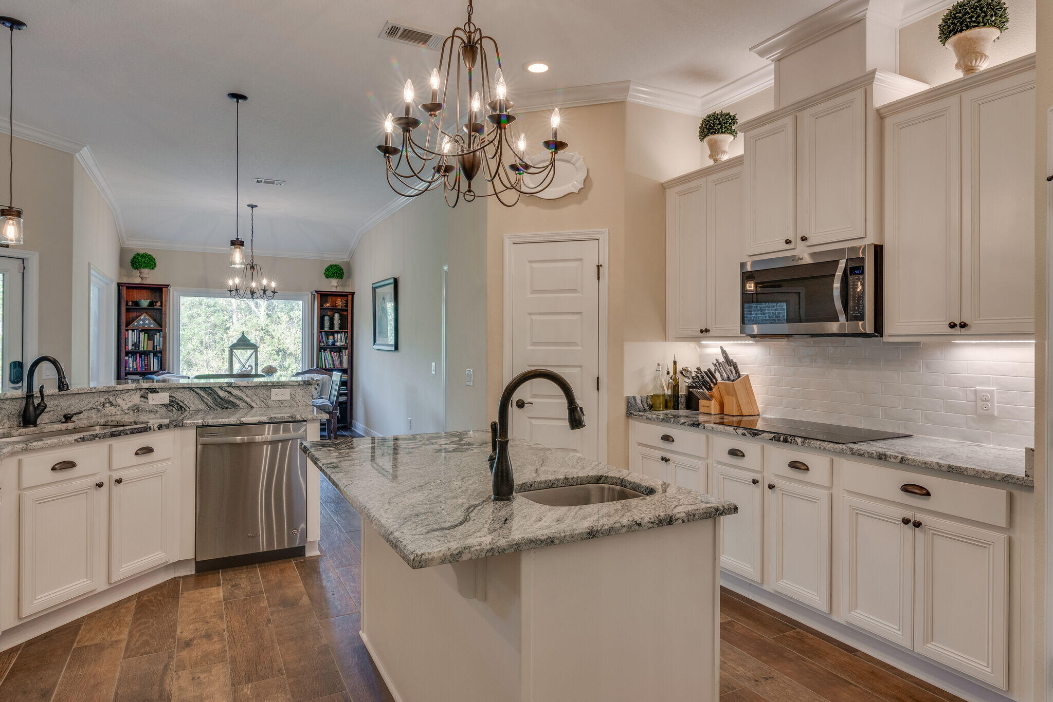 8640 Sand Pine Drive Navarre, FL 32566 - Photo 19 of 58 a kitchen with a sink stove and microwave