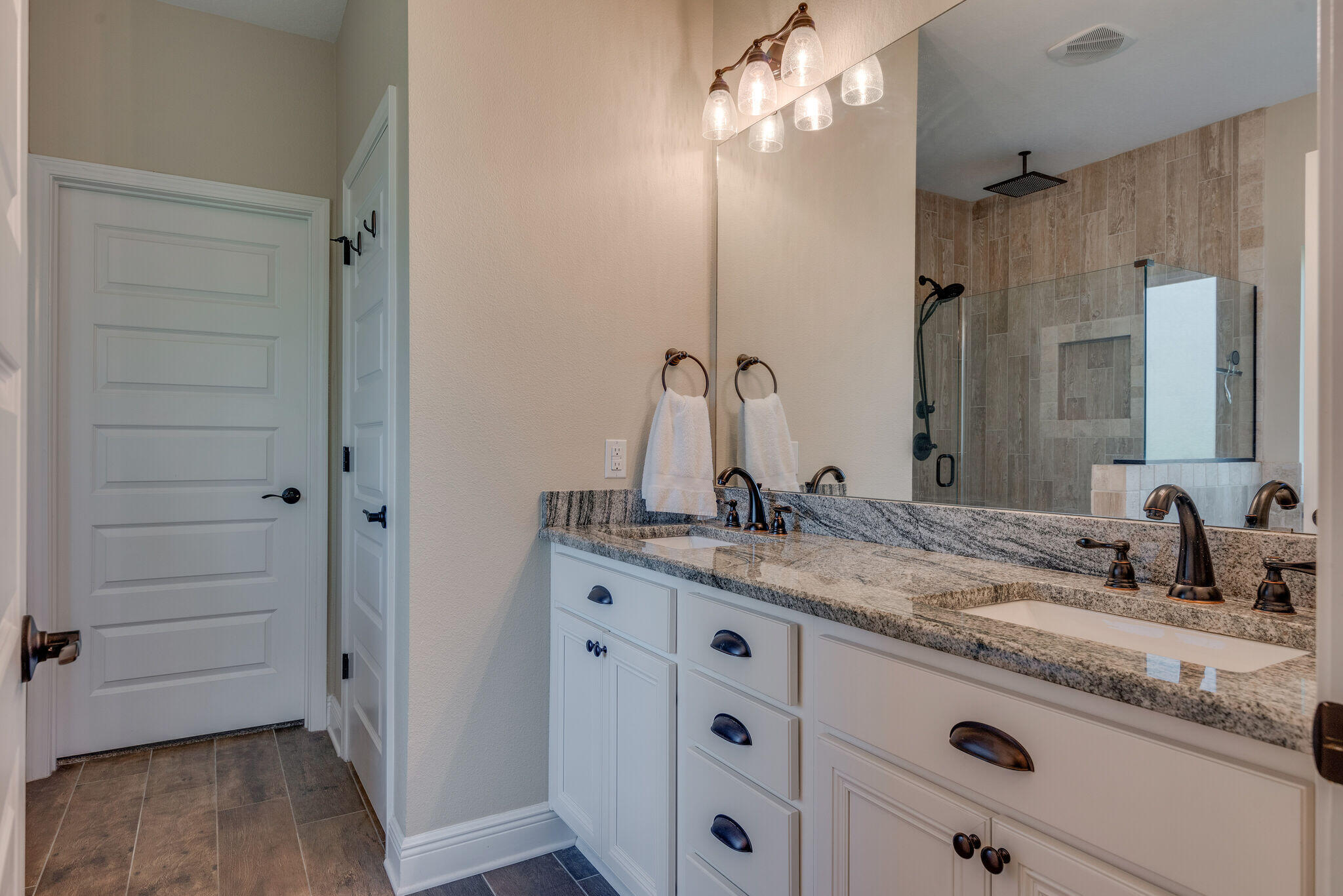 8640 Sand Pine Drive Navarre, FL 32566 - Photo 25 of 58 a bathroom with a granite countertop sink vanity mirror and shower
