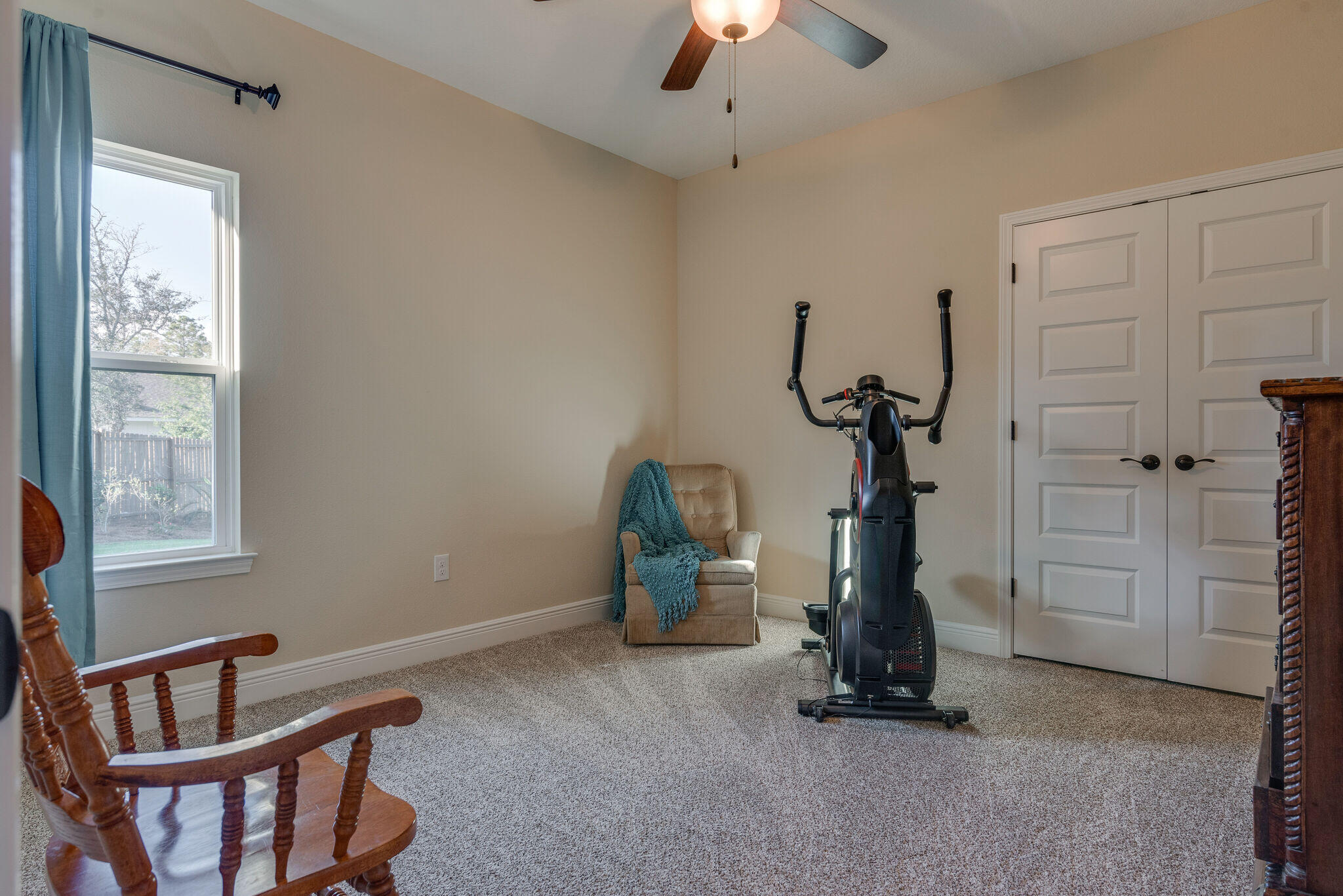 8640 Sand Pine Drive Navarre, FL 32566 - Photo 28 of 58 a room with gym equipment and windows