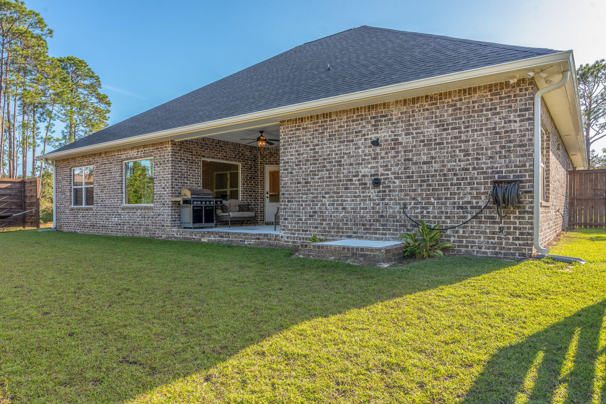 8640 Sand Pine Drive Navarre, FL 32566 - Photo 38 of 58 a backyard of a house with barbeque oven