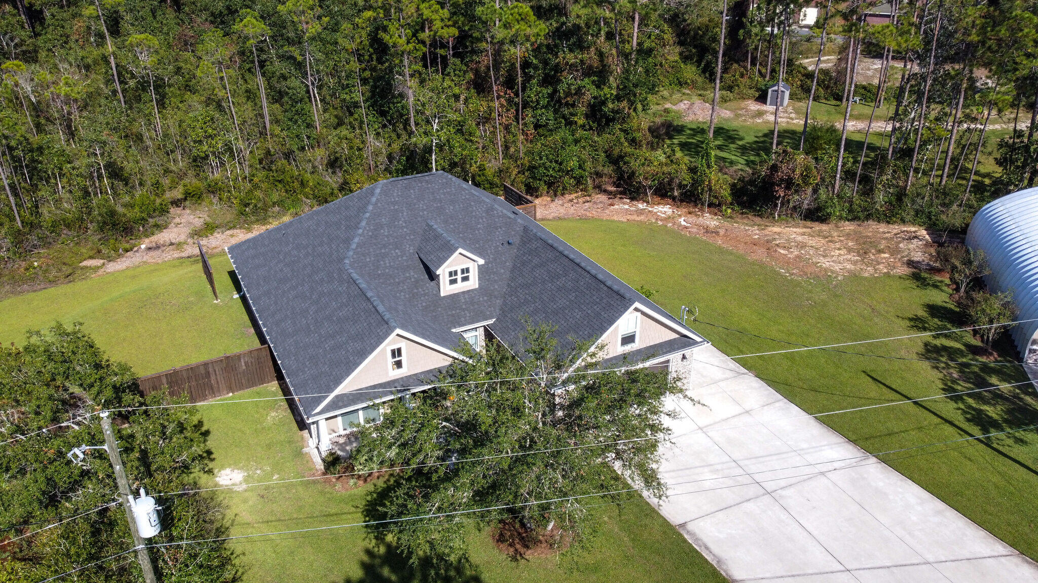 8640 Sand Pine Drive Navarre, FL 32566 - Photo 45 of 58 a view of a house with a yard and sitting area