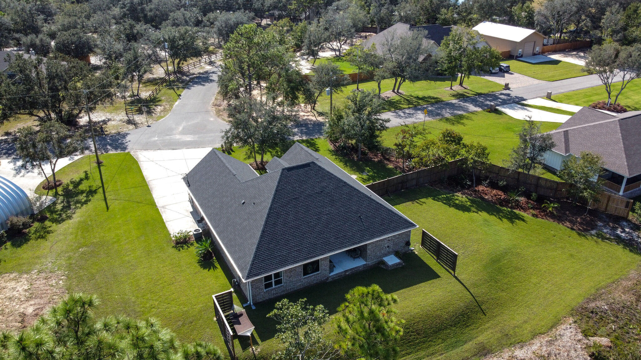 8640 Sand Pine Drive Navarre, FL 32566 - Photo 48 of 58 an aerial view of a house with a swimming pool