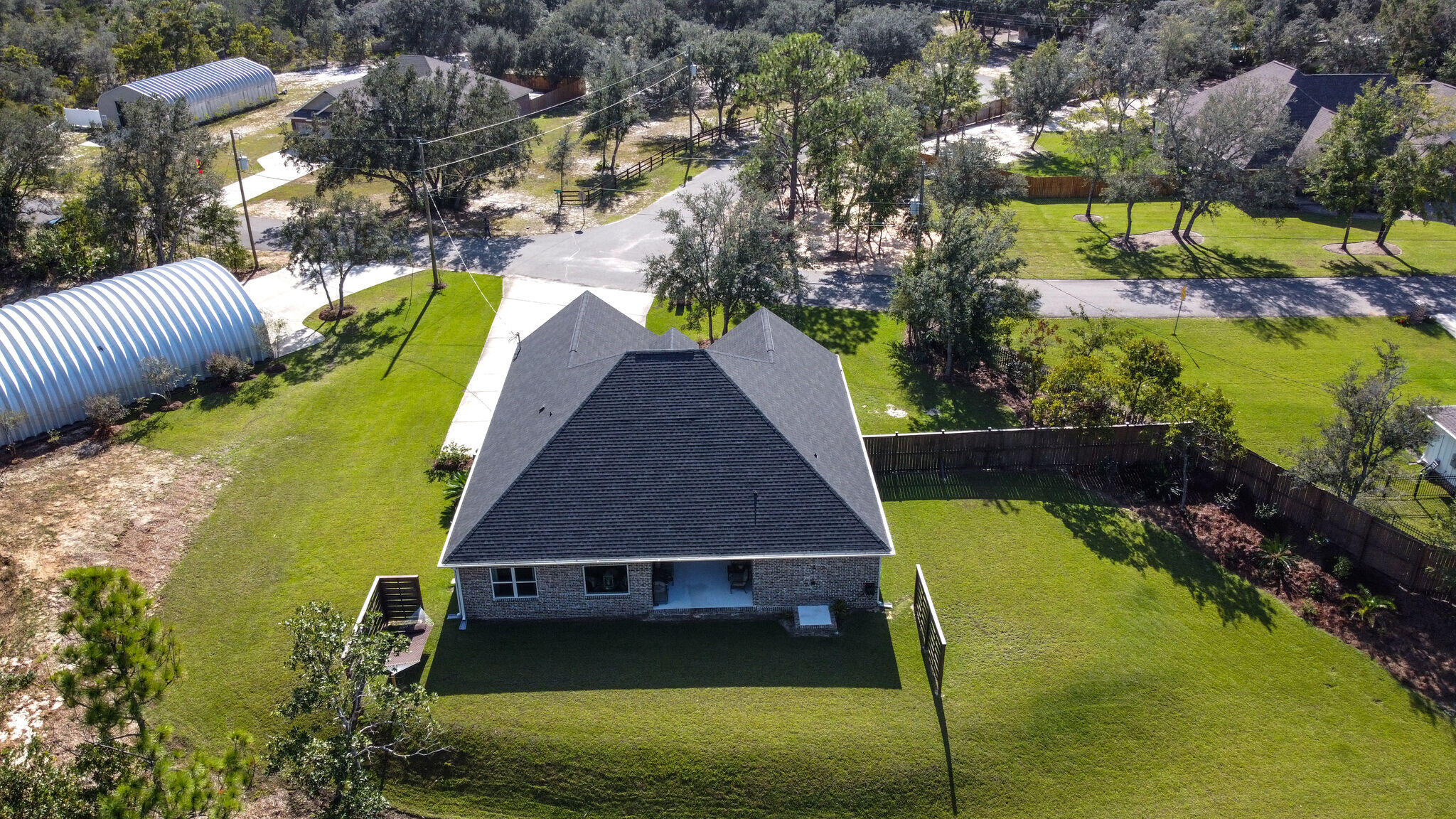 8640 Sand Pine Drive Navarre, FL 32566 - Photo 49 of 58 a view of a house with a yard and sitting area