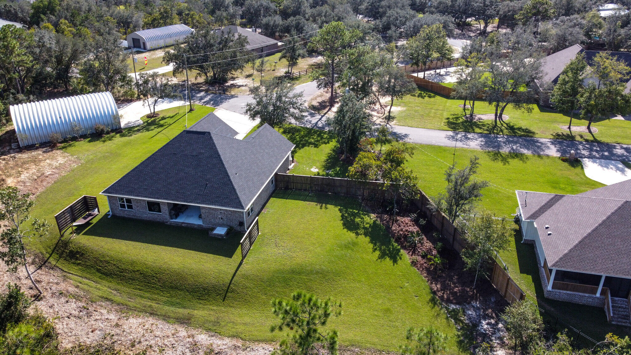 8640 Sand Pine Drive Navarre, FL 32566 - Photo 50 of 58 a view of a backyard with chairs