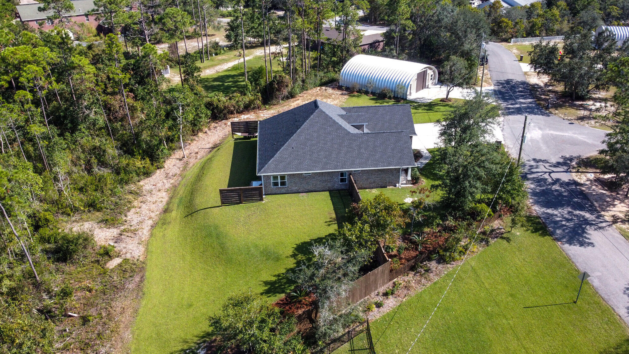 8640 Sand Pine Drive Navarre, FL 32566 - Photo 51 of 58 an aerial view of a house with swimming pool and large trees