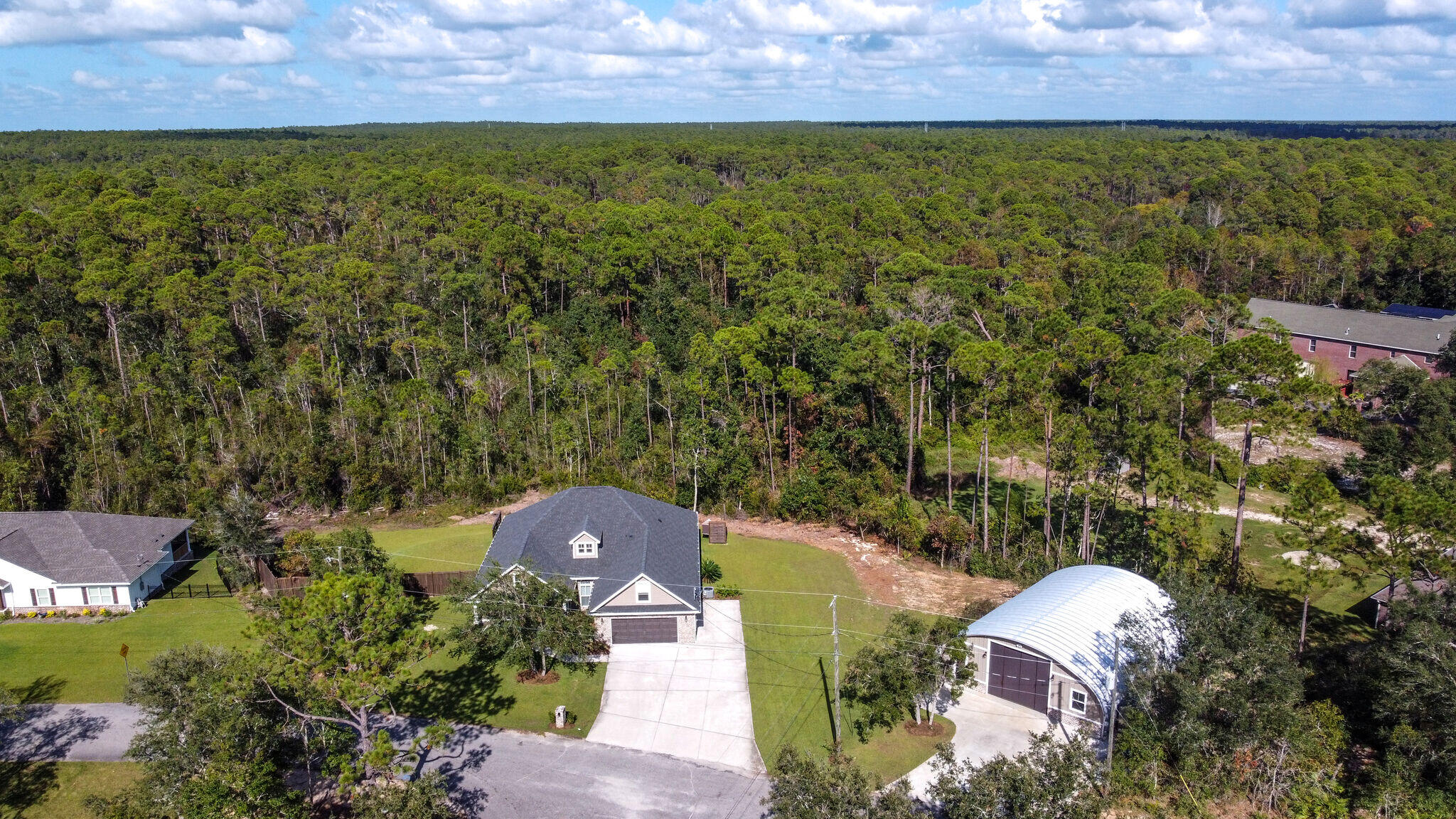 8640 Sand Pine Drive Navarre, FL 32566 - Photo 54 of 58 an aerial view of a house with a yard