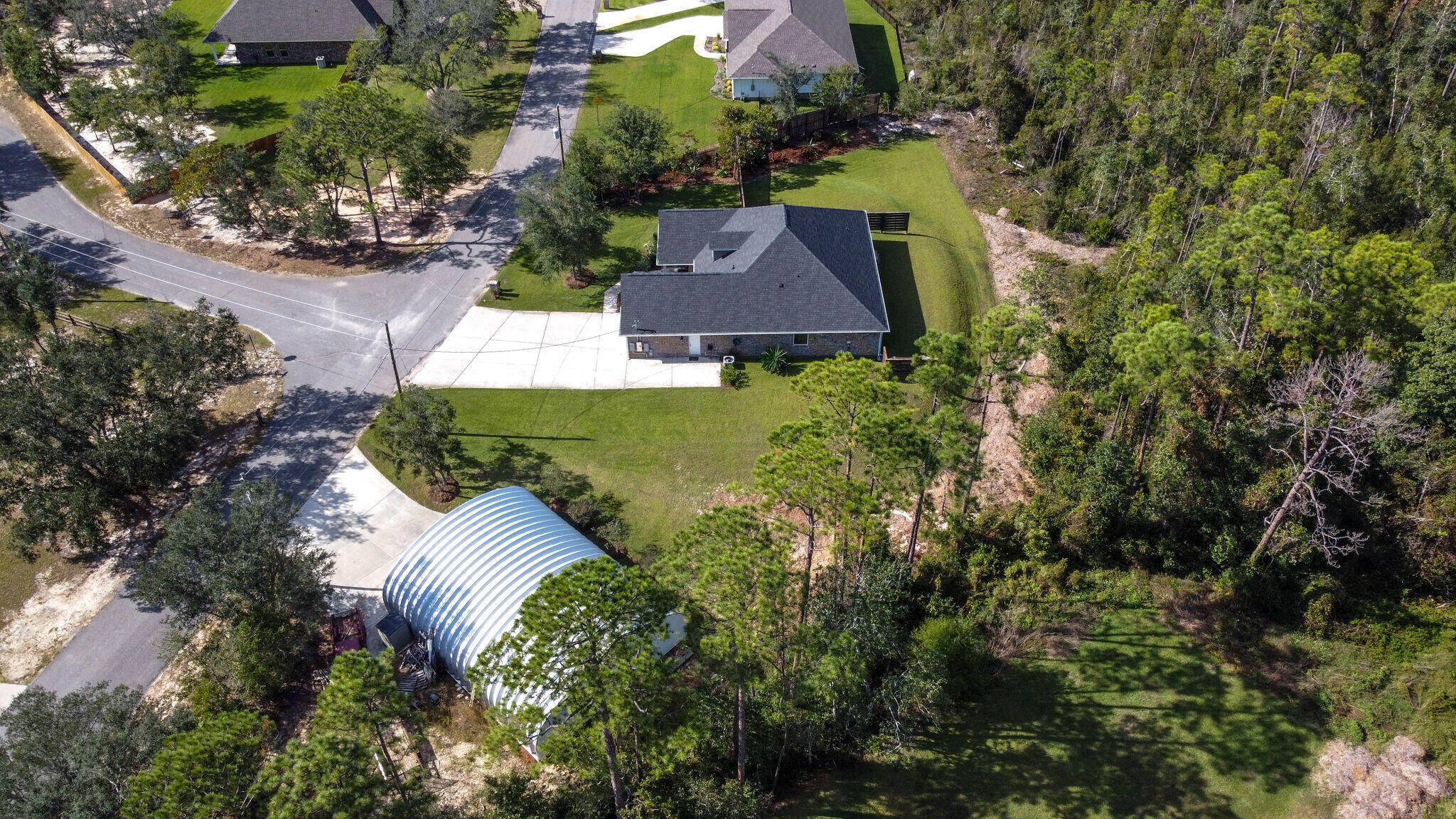 8640 Sand Pine Drive Navarre, FL 32566 - Photo 55 of 58 an aerial view of a house with a yard
