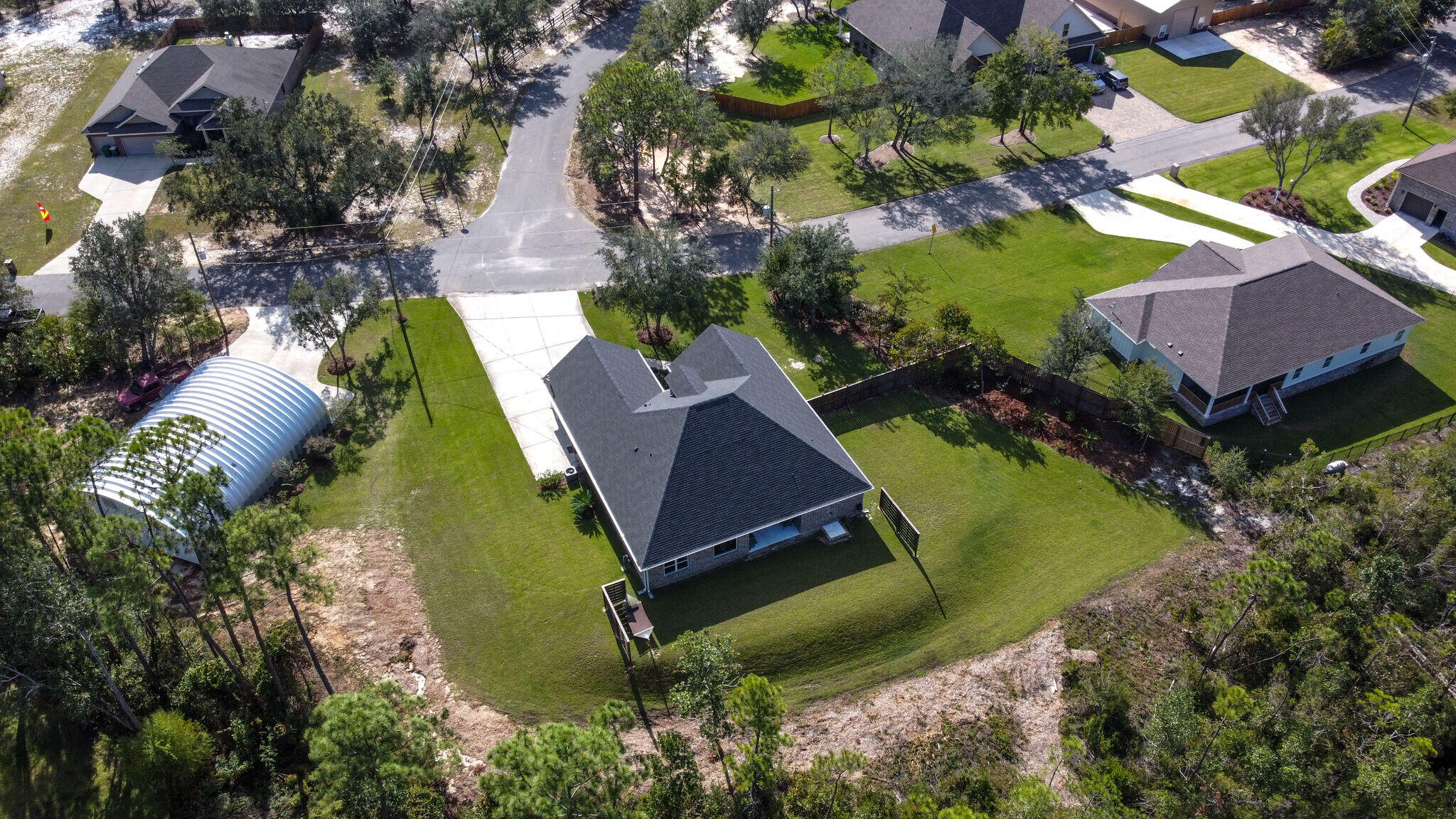8640 Sand Pine Drive Navarre, FL 32566 - Photo 56 of 58 an aerial view of a house with a garden and swimming pool