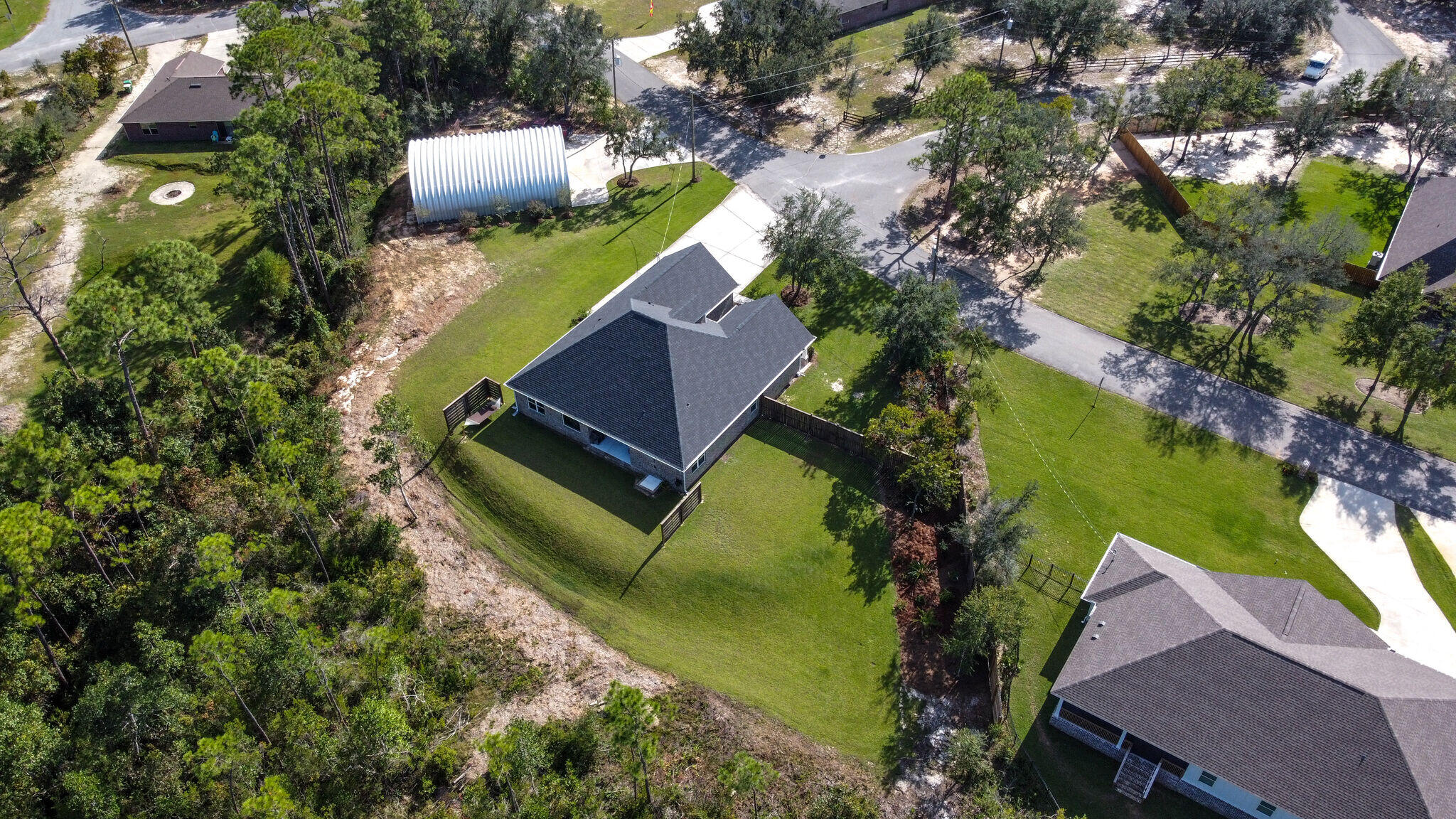 8640 Sand Pine Drive Navarre, FL 32566 - Photo 57 of 58 an aerial view of a house with a garden and swimming pool
