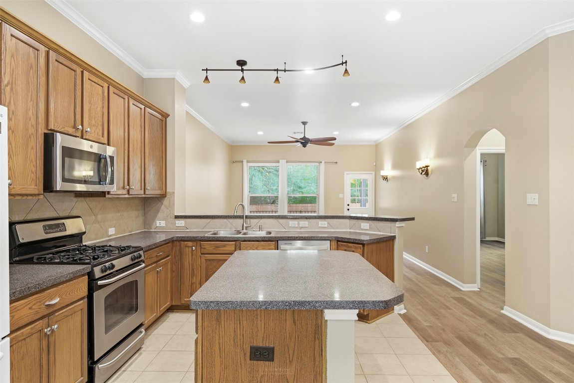 2989 Peacemaker Street Round Rock, TX 78681 - Photo 14 of 40 a kitchen with a stove sink and microwave