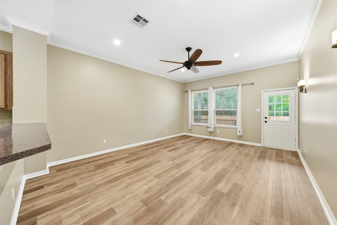 2989 Peacemaker Street Round Rock, TX 78681 - Photo 15 of 40 a view of an empty room with wooden floor and a window