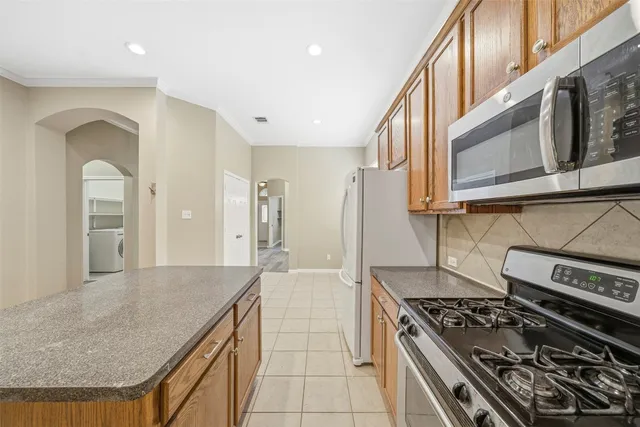 a kitchen with stainless steel appliances granite countertop a stove and a sink