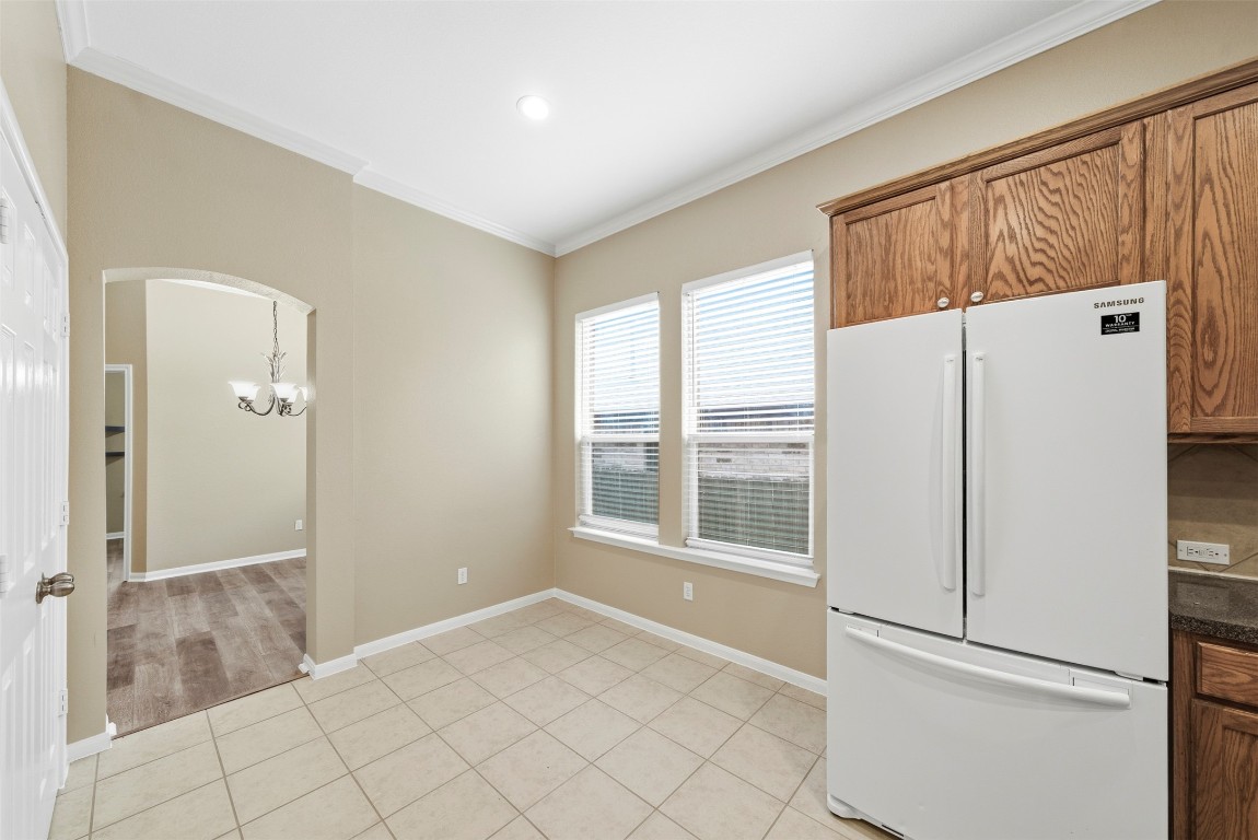 2989 Peacemaker Street Round Rock, TX 78681 - Photo 18 of 40 a view of a kitchen with a refrigerator cabinet and windows