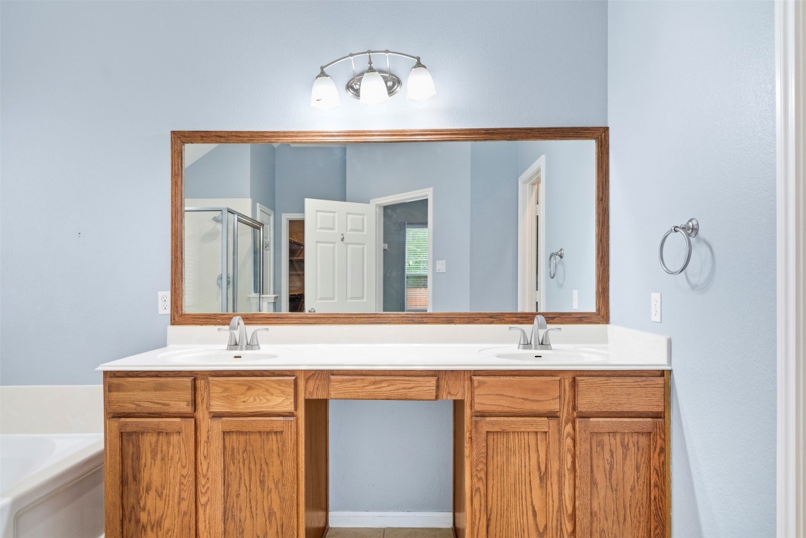 2989 Peacemaker Street Round Rock, TX 78681 - Photo 30 of 40 a bathroom with a sink and a mirror