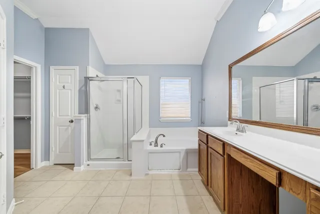 a spacious bathroom with a tub sink and mirror