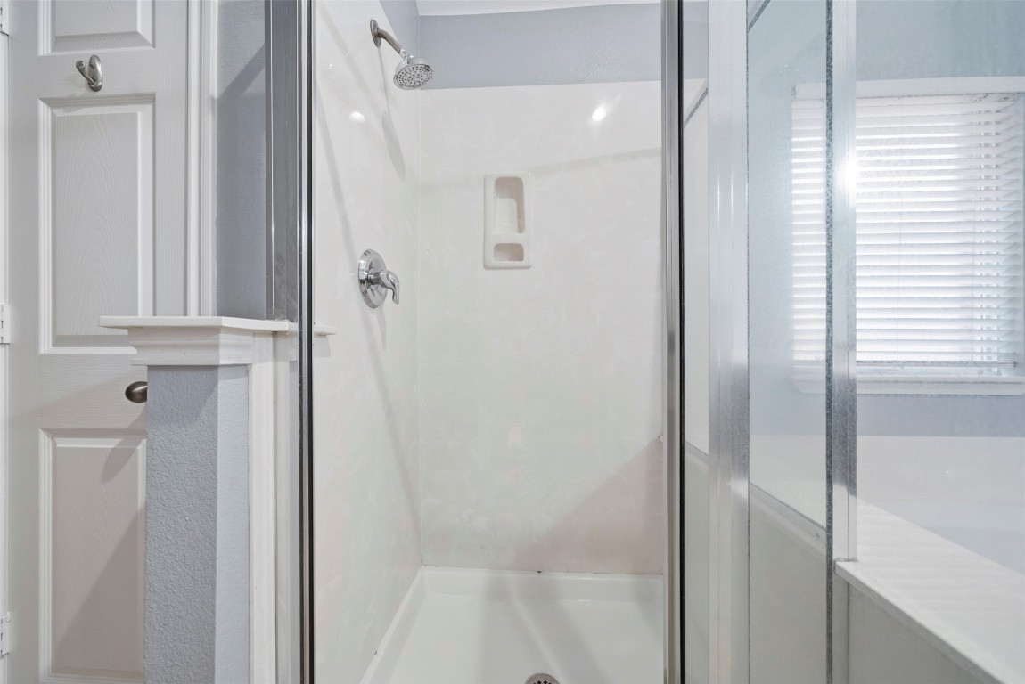 2989 Peacemaker Street Round Rock, TX 78681 - Photo 33 of 40 a bathroom with a glass shower door
