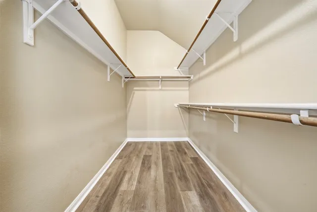 a view of a room with wooden floor