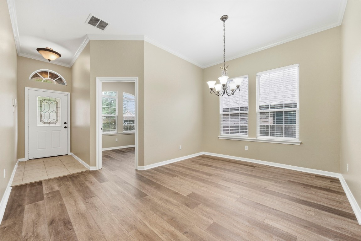 2989 Peacemaker Street Round Rock, TX 78681 - Photo 4 of 40 a view of an empty room with window and cabinet