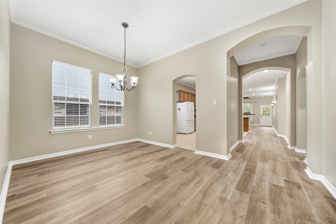 2989 Peacemaker Street Round Rock, TX 78681 - Photo 5 of 40 a view of empty room with wooden floor and fan